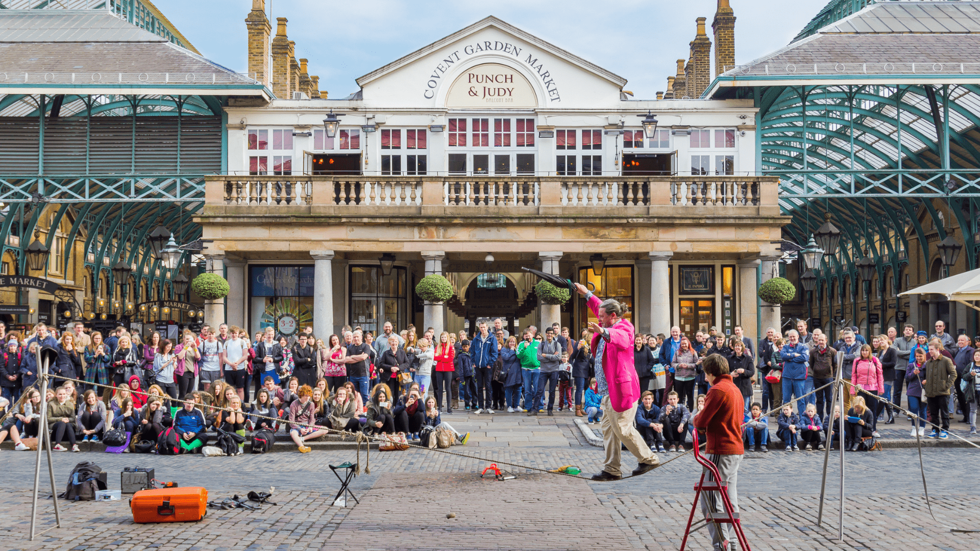 People are in front of the market buidling